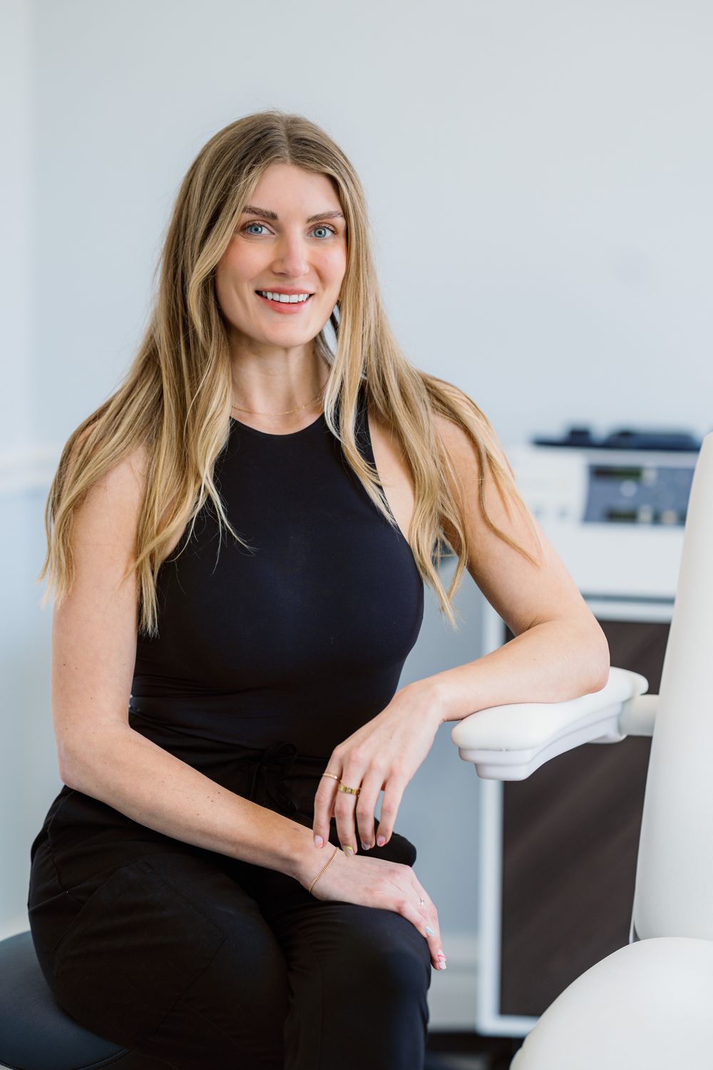 Smiling woman in dental office setting.