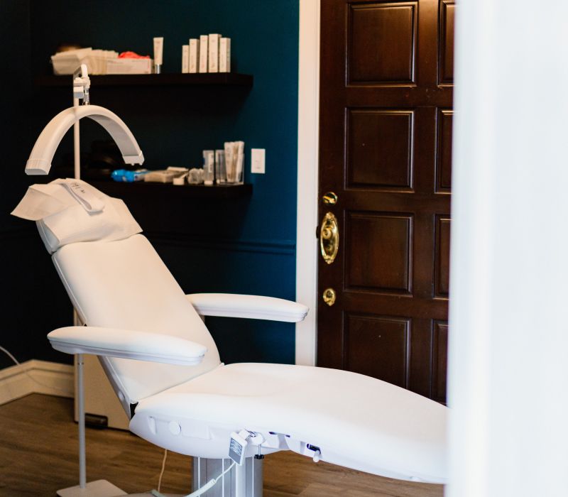 Medical examination room with treatment chair and supplies.