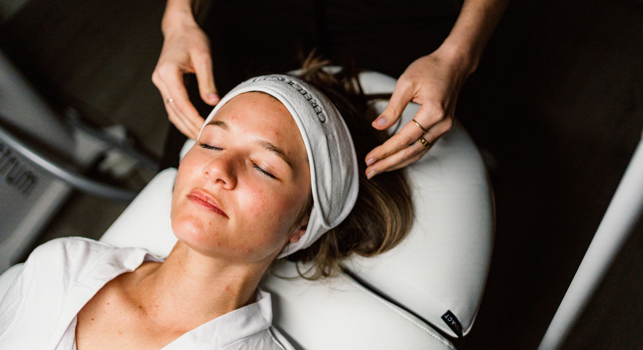 Hinsdale skin care model receiving a facial treatment in spa.