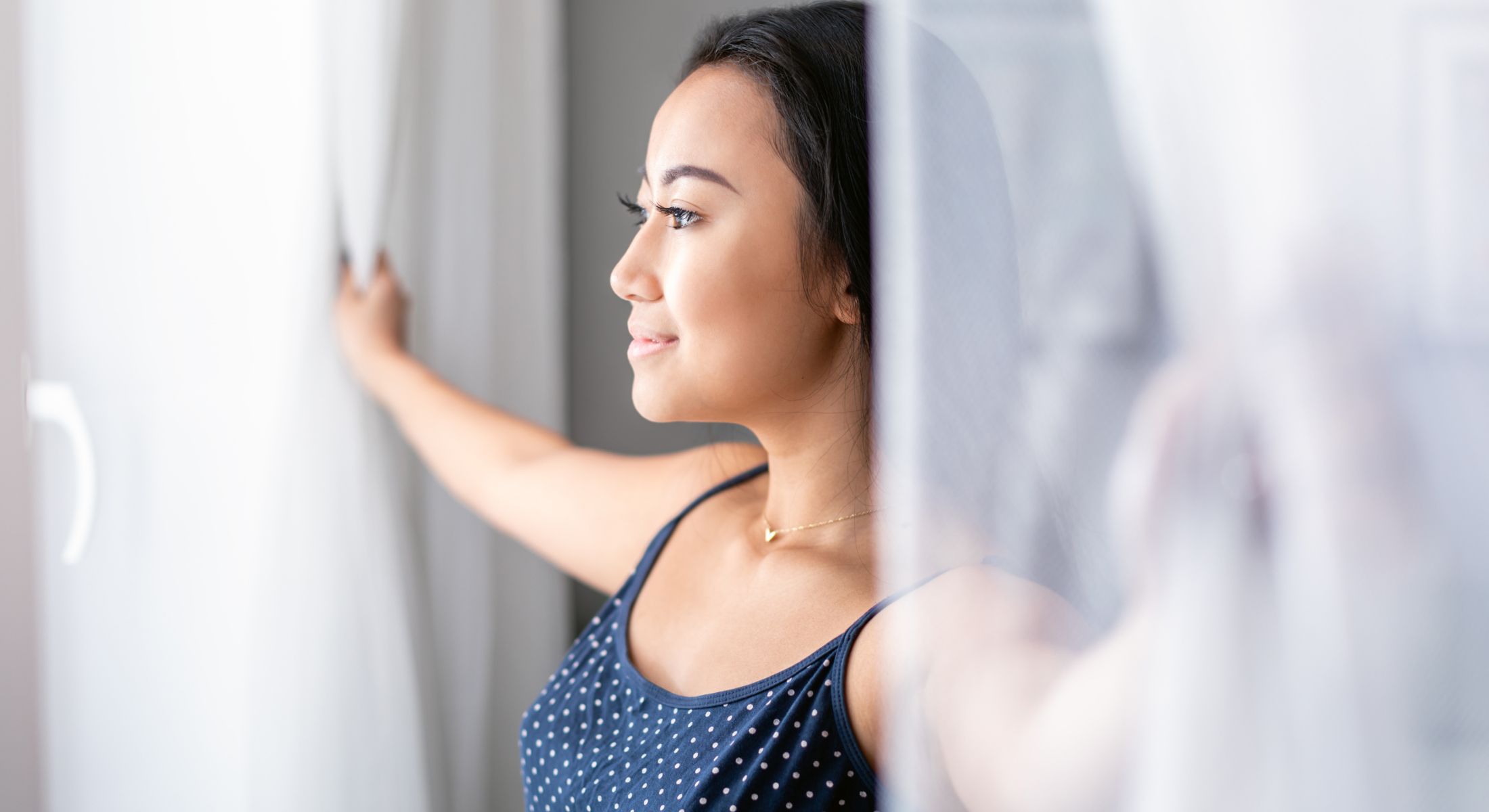 Hinsdale IV therapy model opening curtains, enjoying natural light.