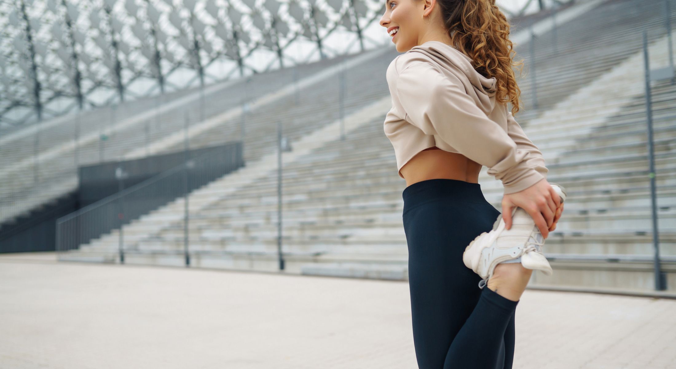 Woman stretching before workout in athletic wear.
